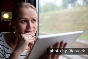 woman with tablet on train