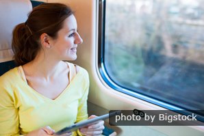 woman on train with tablet